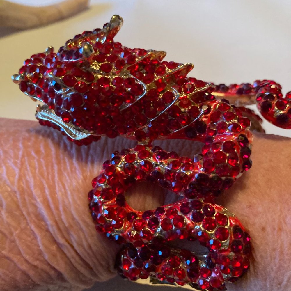 Striking large red jewel encrusted and gold tone dragon clamper bracelet